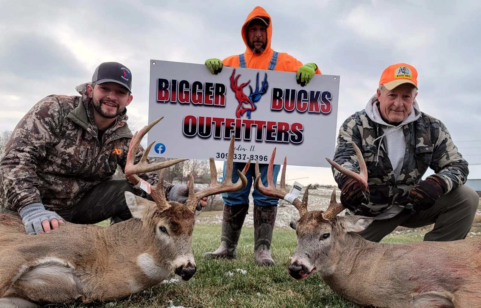 Hunters with whitetail bucks and the Bigger Bucks Outfitters banner in Media Illinois