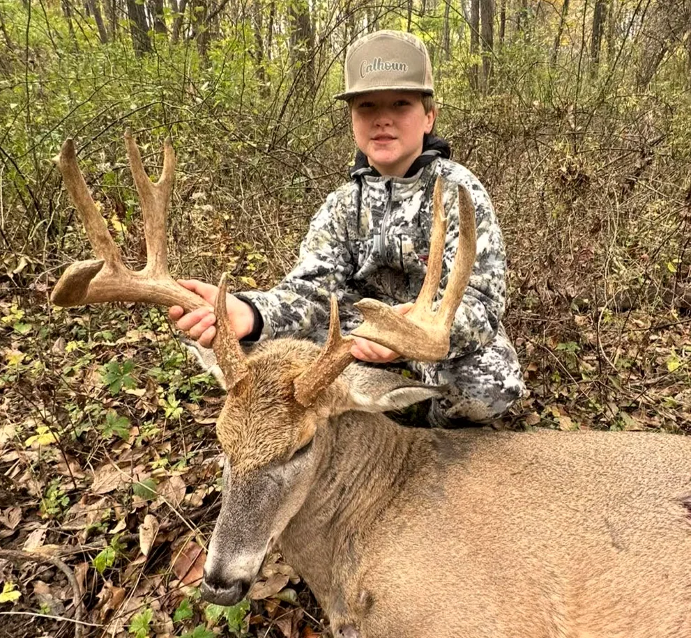 Young hunter with a mature Illinois whitetail taken at Bigger Bucks Outfitters