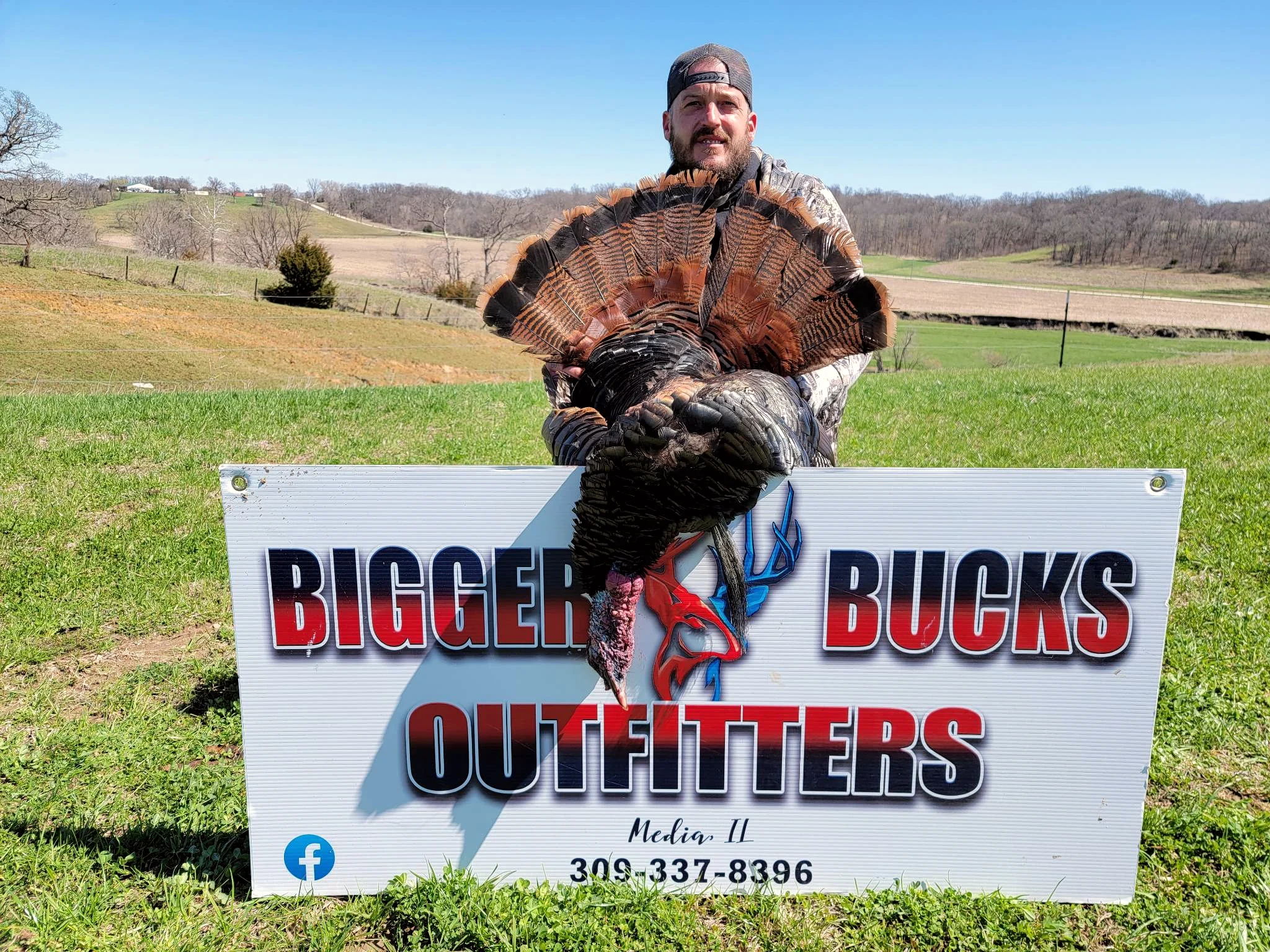 Hunters with spring gobblers and the Bigger Bucks Outfitters banner in Media Illinois